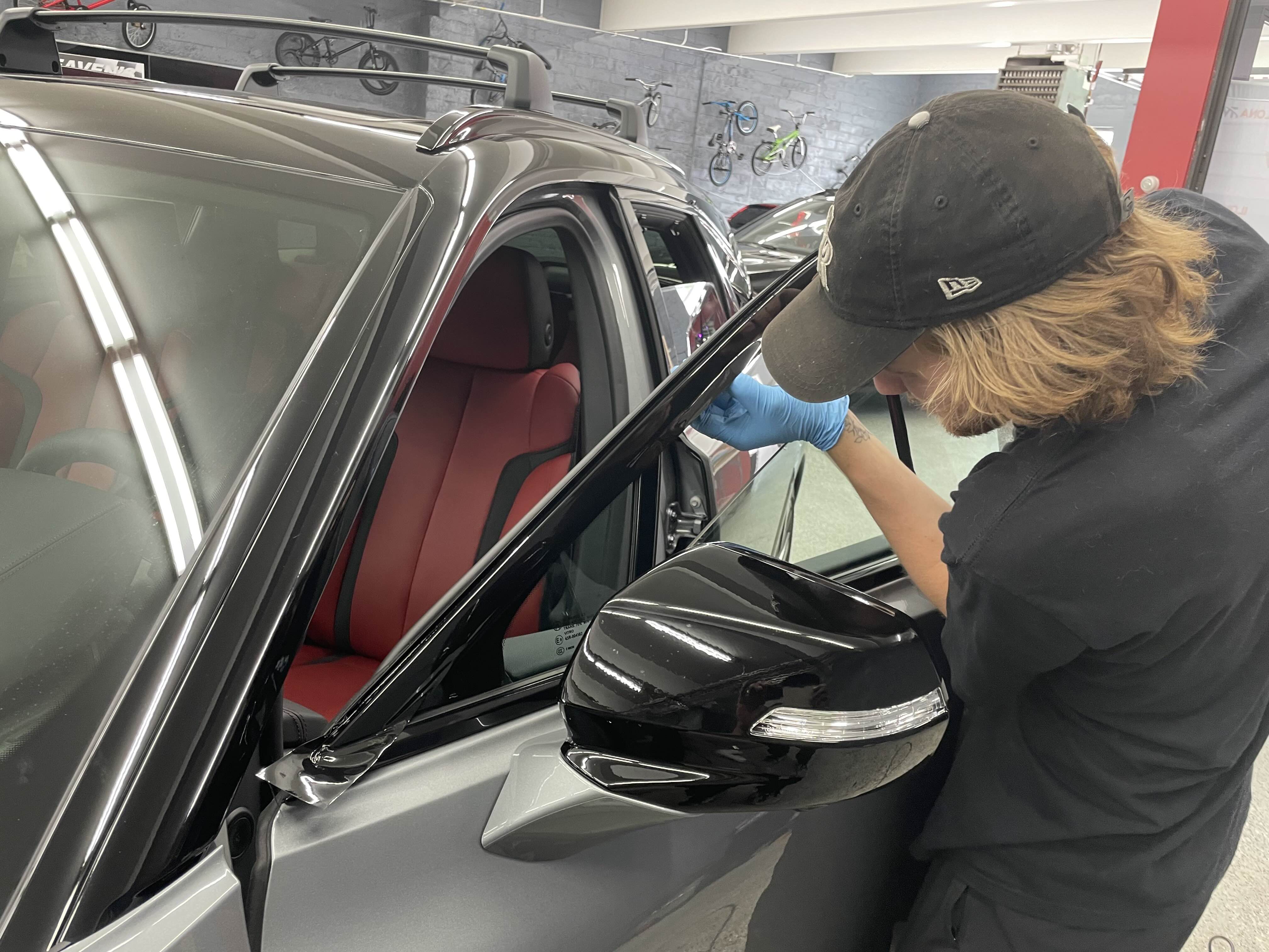 Team Member Performing Detailed Mirror and Window Work